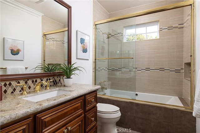 full bathroom featuring toilet, shower / bath combination with glass door, decorative backsplash, and vanity