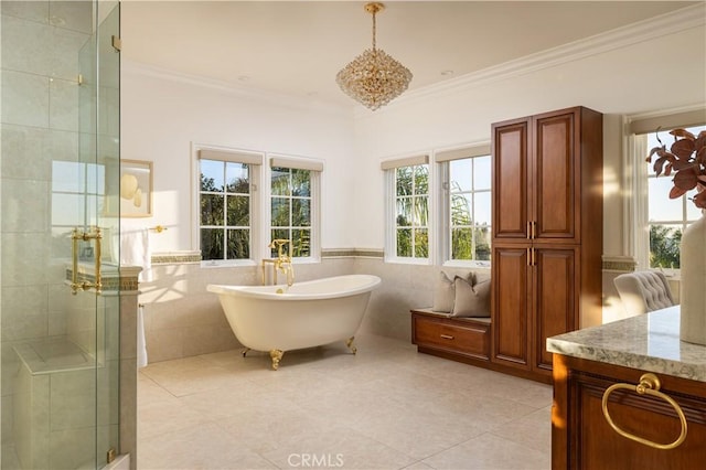 bathroom with shower with separate bathtub, tile patterned flooring, tile walls, ornamental molding, and vanity