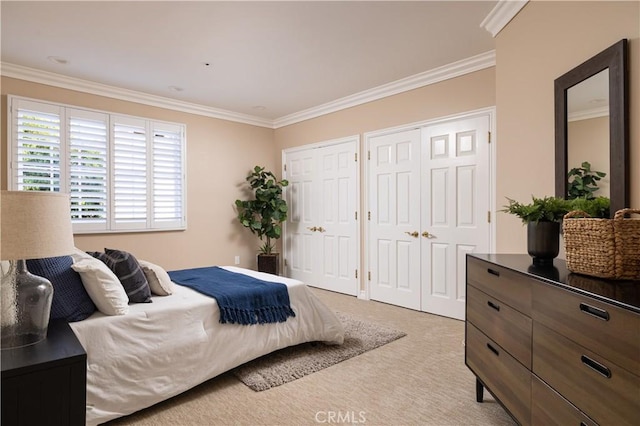 carpeted bedroom featuring crown molding