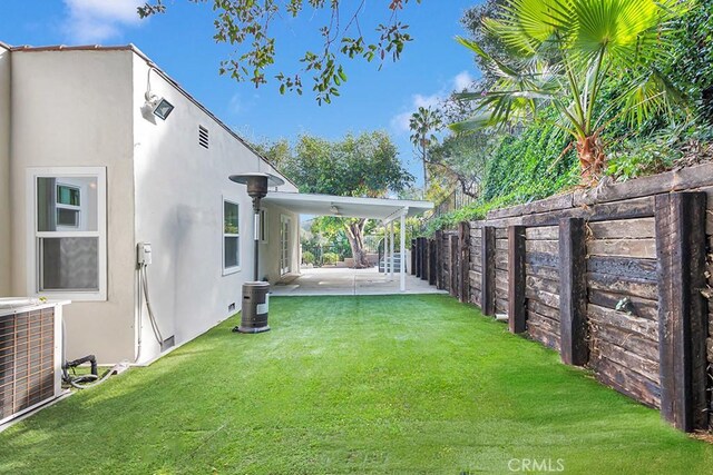 view of yard featuring central AC unit and a patio