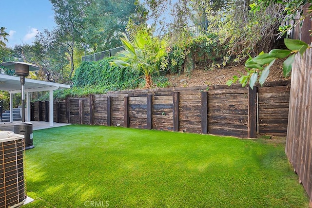 view of yard with central AC unit and a patio