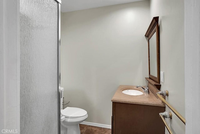 bathroom with toilet, tile patterned flooring, and vanity