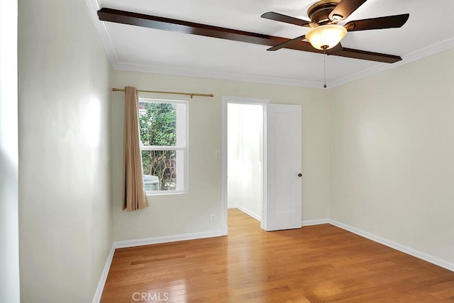 empty room featuring light wood-type flooring, ceiling fan, and ornamental molding