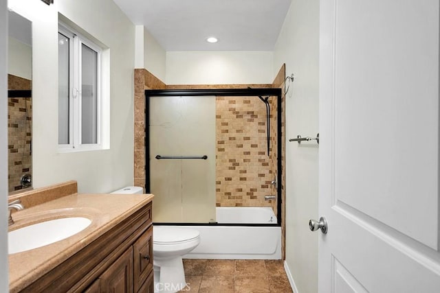 full bathroom featuring shower / bath combination with glass door, vanity, and toilet