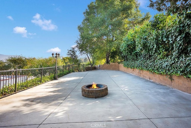 view of patio / terrace featuring an outdoor fire pit