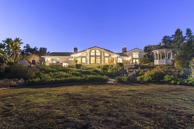 view of front of house featuring a front yard and a gazebo