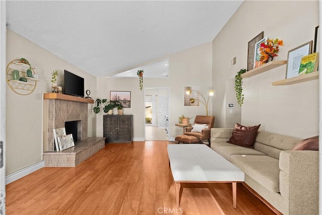 living room with wood-type flooring and vaulted ceiling