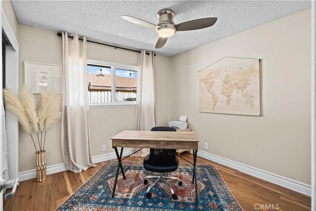 office featuring wood-type flooring, ceiling fan, and a textured ceiling