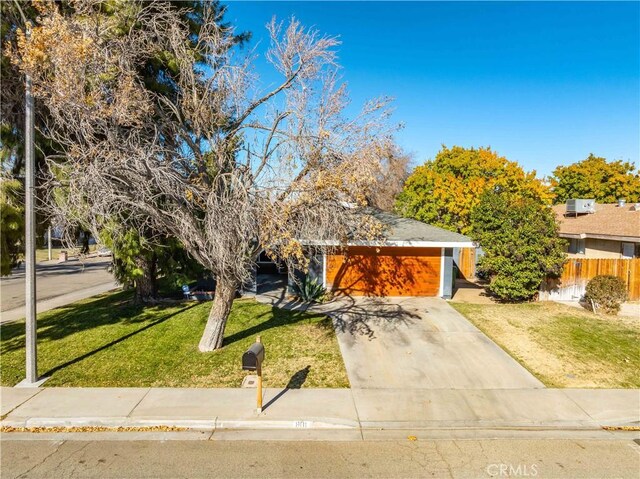 obstructed view of property with a garage and a front yard