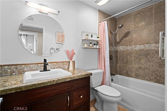 full bathroom with toilet, vanity, shower / bath combo, and tasteful backsplash