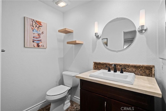 bathroom with tasteful backsplash, vanity, and toilet