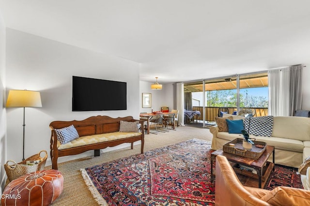 living room featuring floor to ceiling windows and carpet flooring