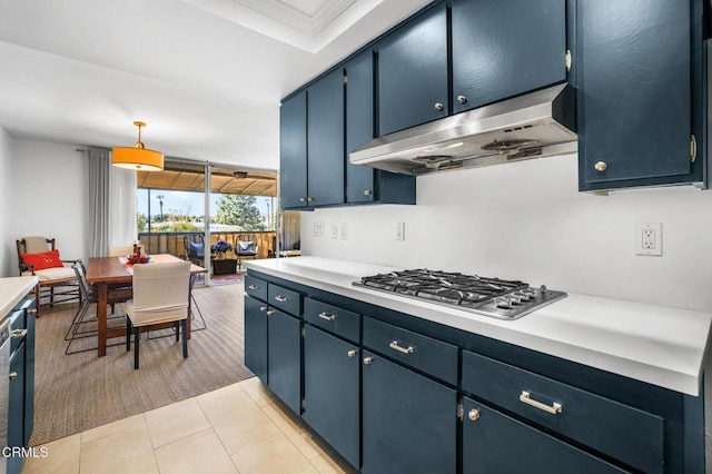 kitchen featuring stainless steel gas stovetop, blue cabinets, hanging light fixtures, and light tile patterned floors