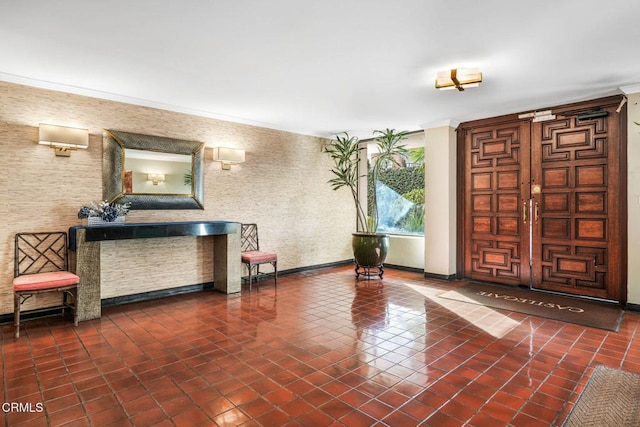 foyer featuring tile patterned flooring and ornamental molding