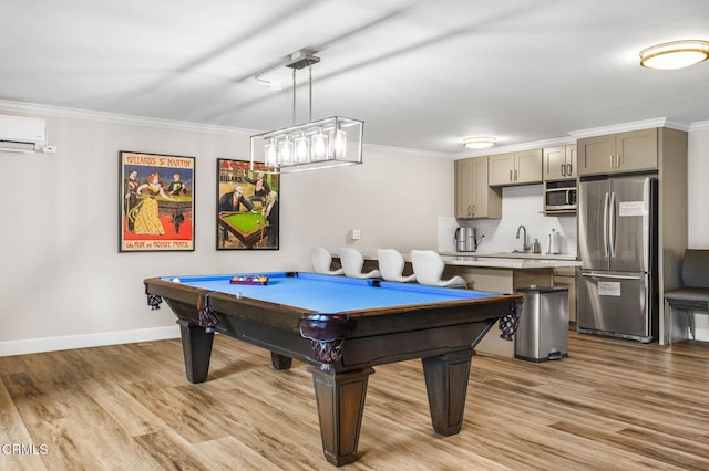 playroom with billiards, sink, a wall unit AC, crown molding, and light wood-type flooring