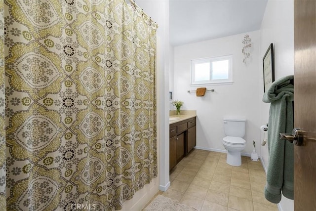 full bathroom featuring toilet, vanity, tile patterned floors, and shower / bath combo with shower curtain