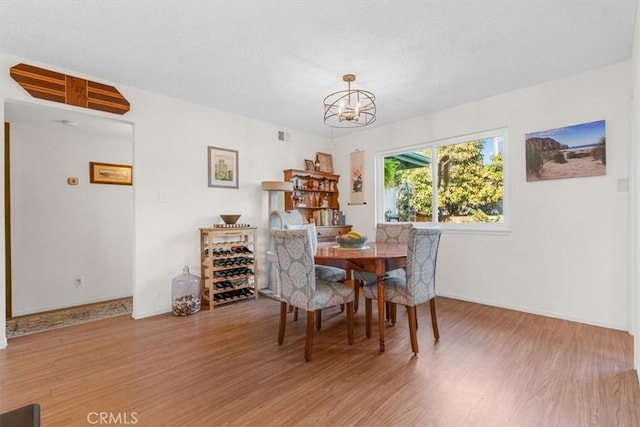 dining space featuring a notable chandelier and hardwood / wood-style floors