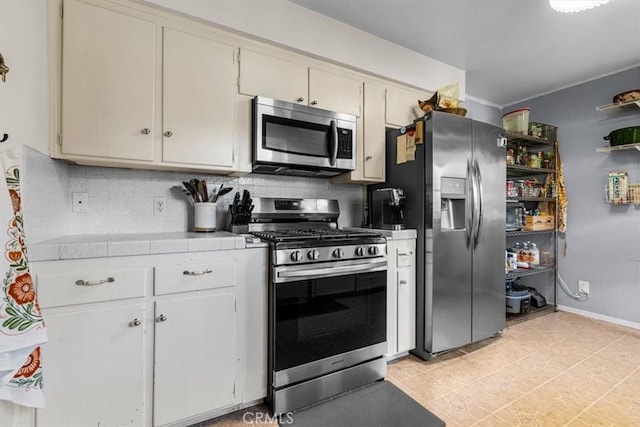 kitchen featuring stainless steel appliances and tasteful backsplash