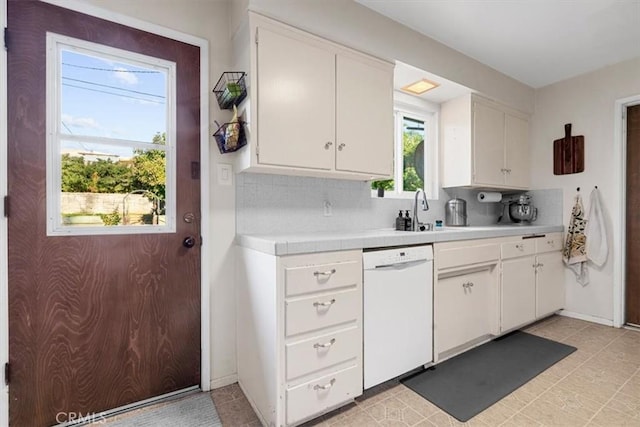 kitchen featuring sink, white cabinets, decorative backsplash, and dishwasher