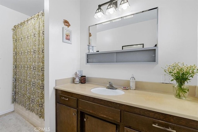 bathroom with shower / tub combo and vanity