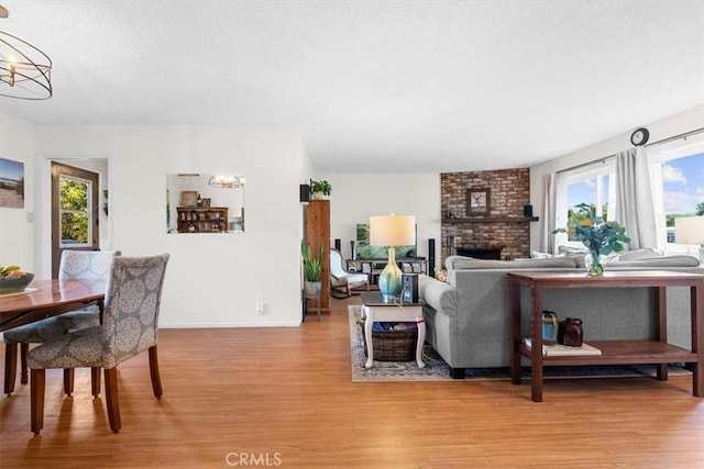 living room with a fireplace, a healthy amount of sunlight, and hardwood / wood-style floors