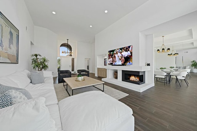 living room with dark wood-type flooring and a chandelier