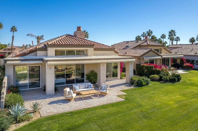 rear view of property featuring a yard, an outdoor hangout area, and a patio