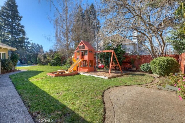 view of jungle gym featuring fence and a yard