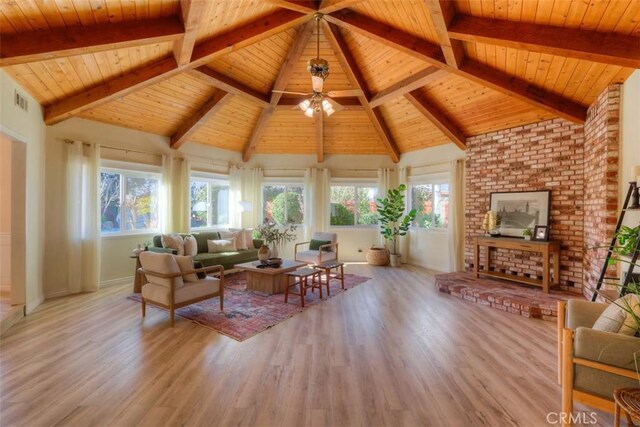 living room featuring wood ceiling, light hardwood / wood-style flooring, beamed ceiling, and plenty of natural light