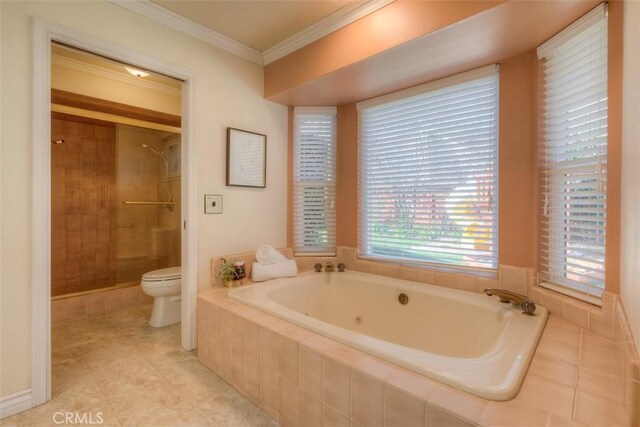 bathroom with a tile shower, ornamental molding, a garden tub, and toilet