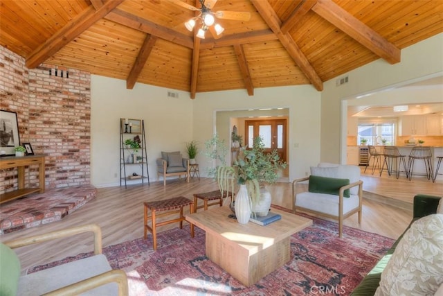 living room with hardwood / wood-style floors, wooden ceiling, and beamed ceiling