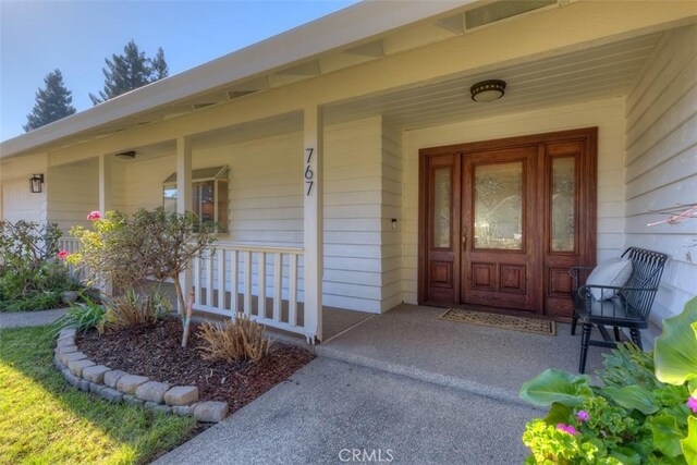 view of exterior entry featuring a porch