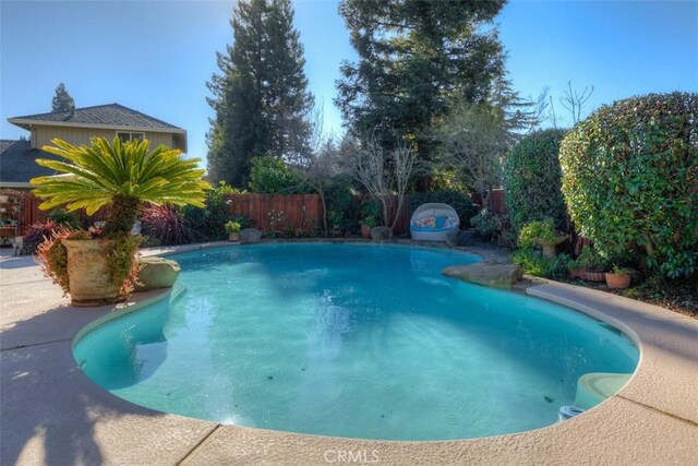 view of swimming pool with a fenced backyard and a fenced in pool
