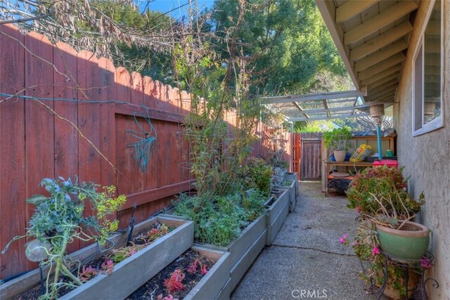 view of yard featuring a fenced backyard and a vegetable garden