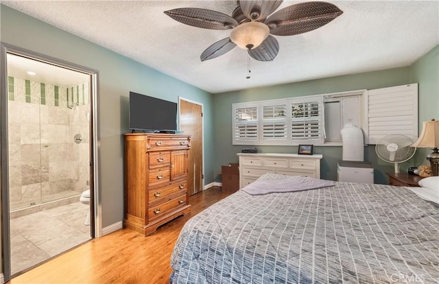 bedroom featuring connected bathroom, a textured ceiling, ceiling fan, and light hardwood / wood-style flooring