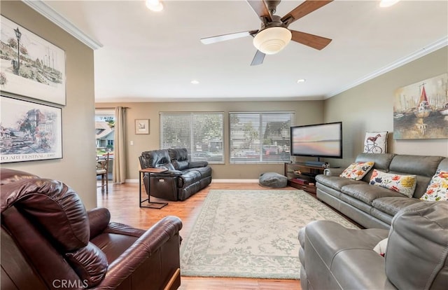 living room with ornamental molding, plenty of natural light, ceiling fan, and light hardwood / wood-style floors