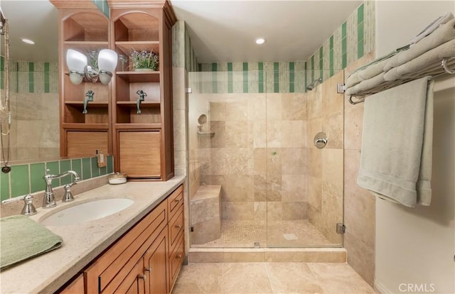 bathroom featuring tile patterned floors, vanity, and an enclosed shower