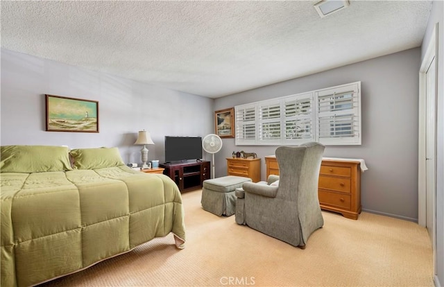 carpeted bedroom with a textured ceiling