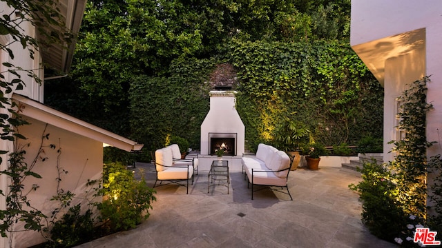 view of patio / terrace with an outdoor fireplace