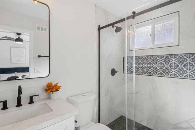 bathroom featuring toilet, an enclosed shower, vanity, and ceiling fan