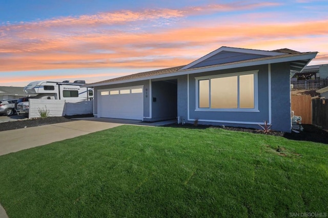 view of front of house with a garage and a lawn