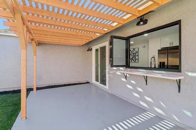 view of patio / terrace with sink and a pergola