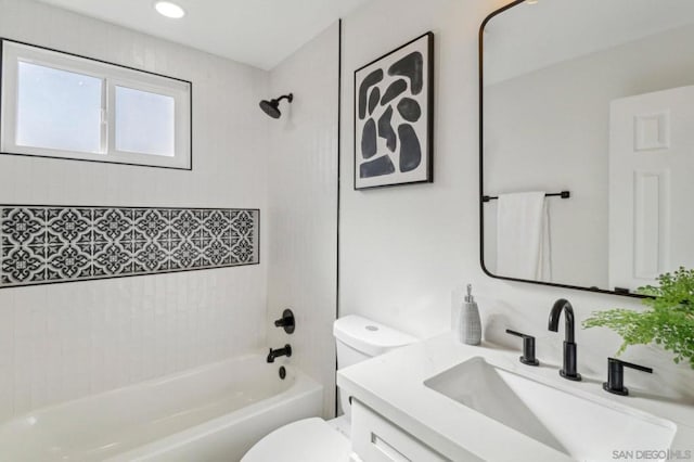 full bathroom with vanity, tiled shower / bath combo, and toilet