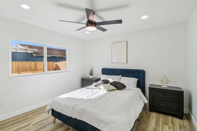 bedroom with ceiling fan and hardwood / wood-style floors