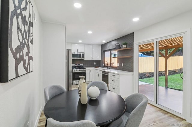 dining area featuring sink and light hardwood / wood-style floors