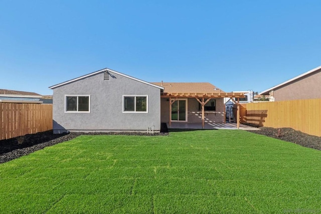 rear view of house featuring a yard and a patio area