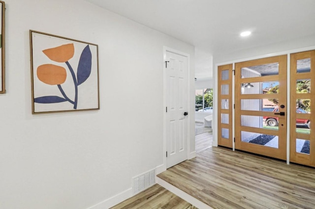 foyer with light hardwood / wood-style floors