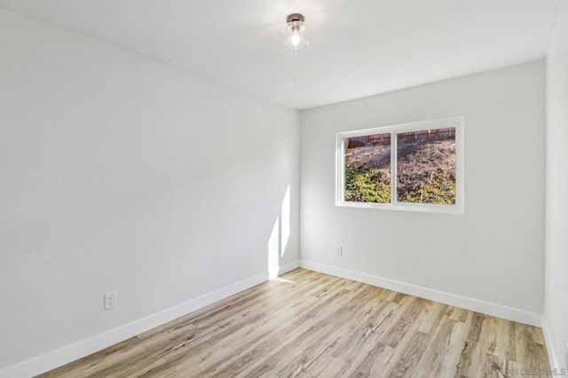 spare room with light hardwood / wood-style floors