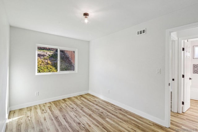 spare room featuring light hardwood / wood-style floors