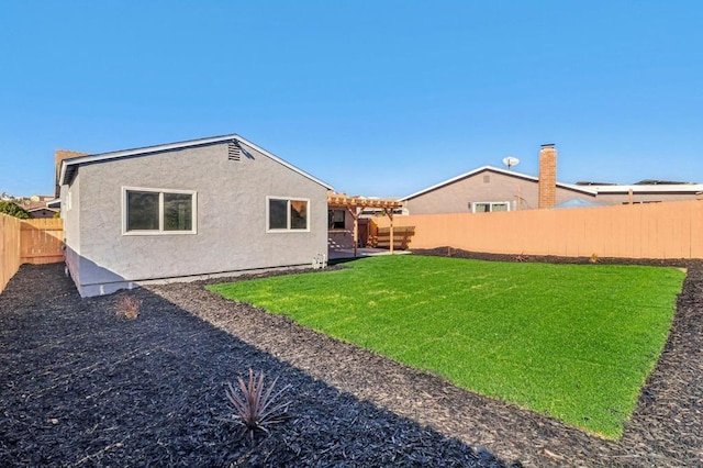 rear view of property with a lawn and a pergola